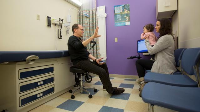 Dr. Benjamin Hoffman speaks with Nancy Minoui about 9 month old Marion Burgess, who suffers from a chronic heart condition, at an appointment at the Dornbecher Children's hospital in Portland