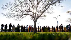 People wait in line looking for jobs during a Job Fair at the Miami Dade College in Miami, Florida