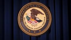 FILE PHOTO: The Department of Justice (DOJ) logo is pictured on a wall after a news conference in New York December 5, 2013.   REUTERS/Carlo Allegri/File Photo