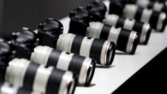 FILE PHOTO: Canon cameras with lenses are pictured at the stand of Japanese camera maker Canon on the press day of the world's largest fair for imaging in Cologne September 17, 2012.   REUTERS/Ina Fassbender/File Photo  