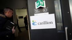 A worker walks past a logo on the door of the site office at a Carillion construction site in central London, Britain, January 16, 2018. REUTERS/Simon Dawson