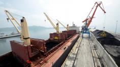 FILE PHOTO - A cargo ship is loaded with coal during the opening ceremony of a new dock at the North Korean port of Rajin