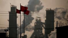 FILE PHOTO: Chinese national flags flutter near a steel factory in Wu'an, Hebei province, China, February 23, 2017.  REUTERS/Thomas Peter/File Photo