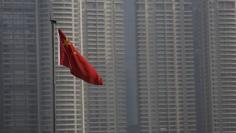 FILE PHOTO: A Chinese flag is seen in front of the financial district of Pudong in Shanghai, China, January 19, 2016.  REUTERS/Aly Song/File Photo - RC18D15B05C0