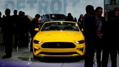 FILE PHOTO: Visitors look at cars in the Ford booth at the North American International Auto Show in Detroit, Michigan, U.S. January 15, 2018.  REUTERS/Jonathan Ernst/File Photo  