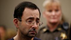 FILE PHOTO:    Larry Nassar, a former team USA Gymnastics doctor who pleaded guilty in November 2017 to sexual assault charges, stands with his legal team during his sentencing hearing in Lansing