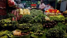 FILE PHOTO: A vegetables vendor waits for customers at a market in Kolkata, India December 13, 2017. REUTERS/Rupak De Chowdhuri/File photo