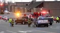 FILE PHOTO: Police investigators are seen at the scene of a shooting at Marshall County High School in Benton Kentucky