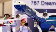 FILE PHOTO: Visitors take pictures of a model of Boeing's 787 Dreamliner during Japan Aerospace 2016 air show in Tokyo, Japan, October 12, 2016.   REUTERS/Kim Kyung-Hoon/File Photo - RC18EDD572A0