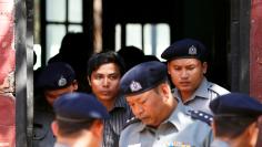 FILE PHOTO - Detained Reuters journalist Kyaw Soe Oo is escorted by police for a court hearing in Yangon, Myanmar January 23, 2018. REUTERS/Stringer 