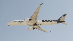 An Airbus A350-1000 flies over Doha International Airport