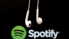 FILE PHOTO - Headphones are seen in front of a logo of online music streaming service Spotify in this  February 18, 2014 illustration picture. REUTERS/Christian Hartmann/File Photo