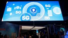 FILE PHOTO - A video promotes the 5G mobile wireless standard at the Qualcomm booth during the 2017 CES in Las Vegas, Nevada January 6, 2017. REUTERS/Steve Marcus 