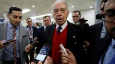 FILE PHOTO: Sen. Chuck Grassley speaks with reporters ahead of votes on Capitol Hill in Washington, U.S., December 6, 2017. REUTERS/Aaron P. Bernstein 