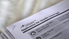 FILE PHOTO - Applications are seen at a rally held by supporters of the Affordable Care Act in Jackson Mississippi