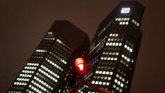 A red traffic light is photographed in front of the head quarters of Germany's largest business bank, Deutsche Bank, in Frankfurt, Germany, December 6, 2017.  REUTERS/Kai Pfaffenbach