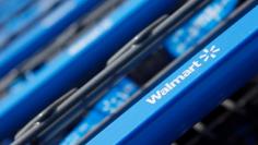 FILE PHOTO --  Shopping carts are seen outside a new Wal-Mart Express store in Chicago July 26, 2011. REUTERS/John Gress/File Photo 