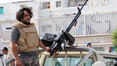 A fighter of the southern Yemeni separatists mans a machine gun mounted on a military vehicle securing an anti-government protest in Aden